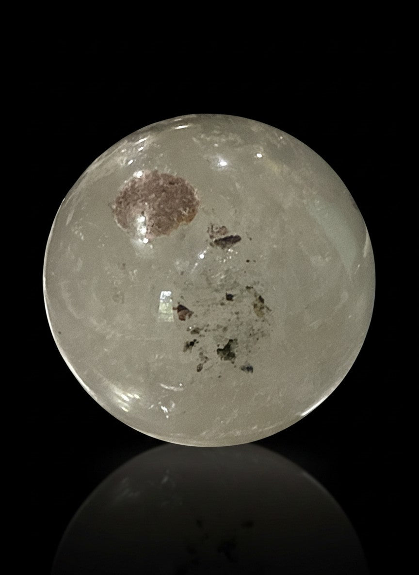 Zebra Industries, LLC garden quartz sphere with hematite inclusions and iron oxide patterns on a black background.