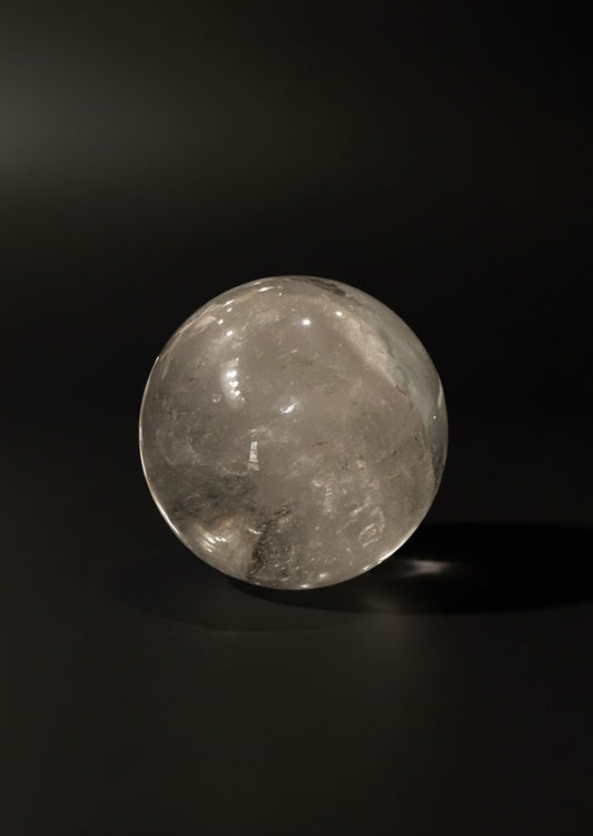 Zebra Industries, LLC 3.5-inch garden quartz sphere with visible hematite inclusions on a dark background.