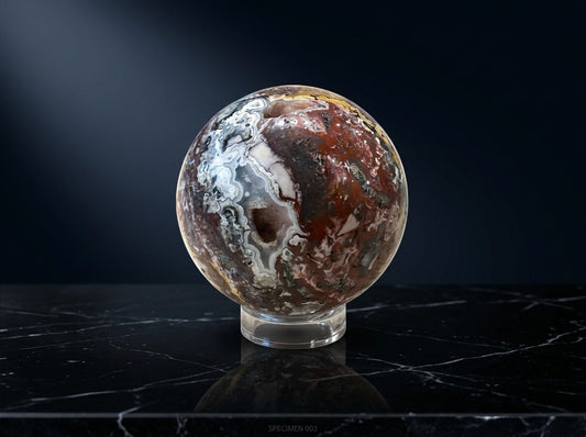 Zebra Industries, LLC Laguna Lace agate sphere with natural druzy cavity and intricate mineral patterns on a stand.