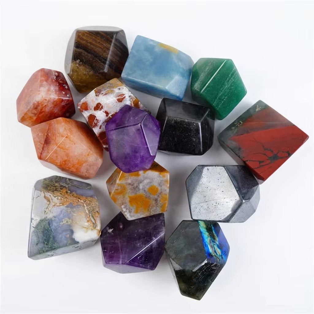 Overhead view of 14 polished freeform mineral palm stones in a circular arrangement on white background, showcasing amethyst purple, blue onyx, red jasper, green aventurine, hematite silver, labradorite iridescent blue, ocean jasper, and tiger eye varieties