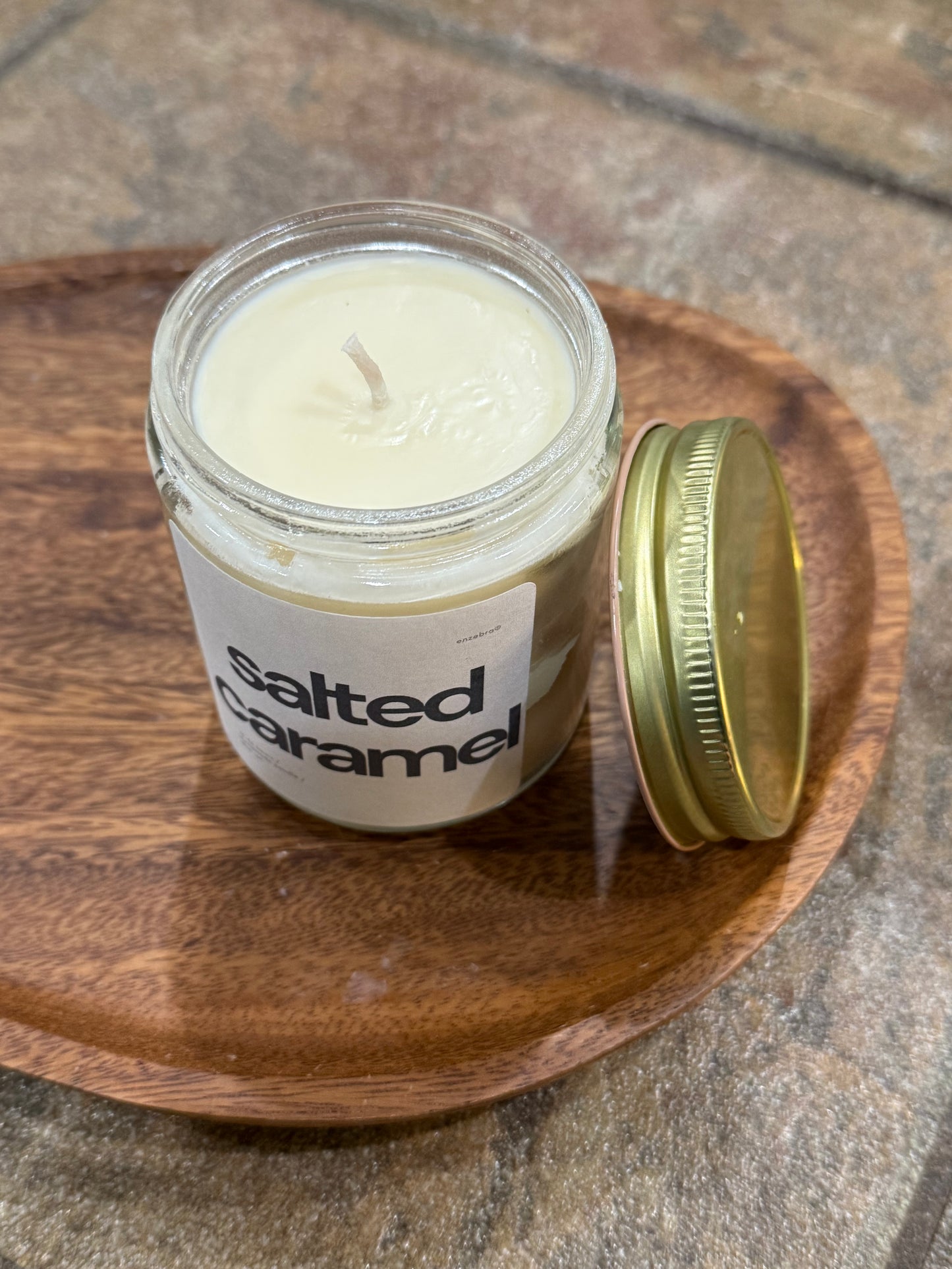 EnZebra Salted Caramel No. 21 — 10 oz clear glass candle vessel lifestyle photo