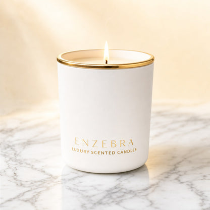 EnZebra Matte White 8oz luxury scented candle — lit on Carrara marble