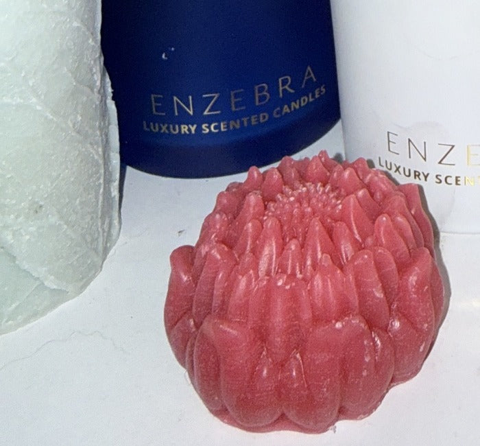 ENZ-WMR EnZebra Rose Wax Melt Embed — small hand-formed rose bud, deep red, shown alongside EnZebra vessel candle