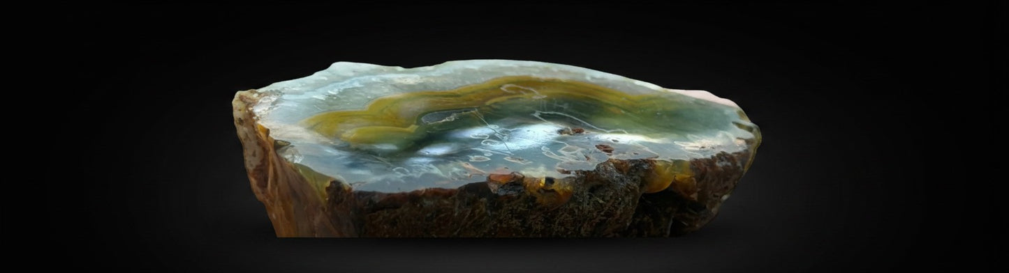 Zebra Industries, LLC natural agate geode slice with brown, amber, and cream banded patterns and crystalline layers.