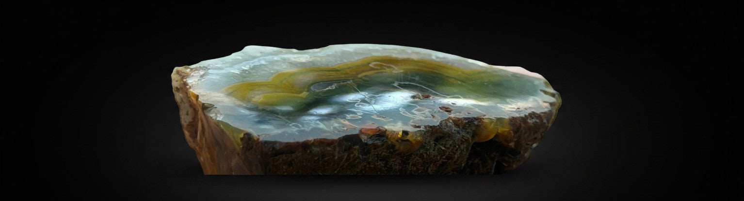 Zebra Industries, LLC natural agate geode slice with brown, amber, and cream banded patterns and crystalline layers.