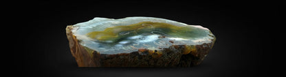 Zebra Industries, LLC natural agate geode slice with brown, amber, and cream banded patterns and crystalline layers.