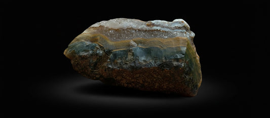 Zebra Industries, LLC natural agate geode slice with brown, amber, and cream banded patterns and crystalline structure.