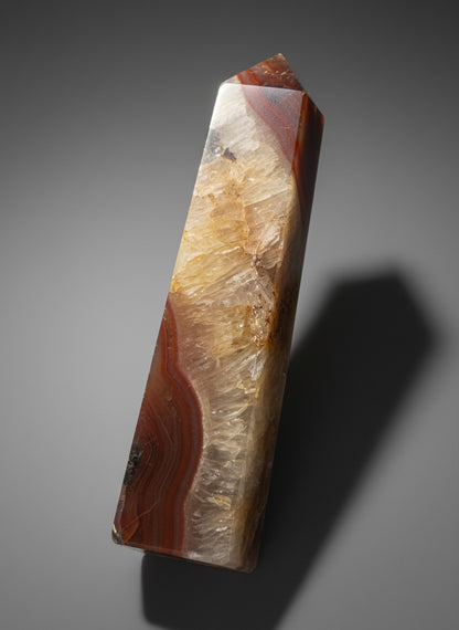 Zebra Industries, LLC polished carnelian agate geode tower with translucent orange banding and sparkling druzy quartz.