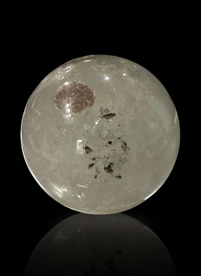 Zebra Industries, LLC garden quartz sphere with hematite inclusions and iron oxide patterns on a black background.