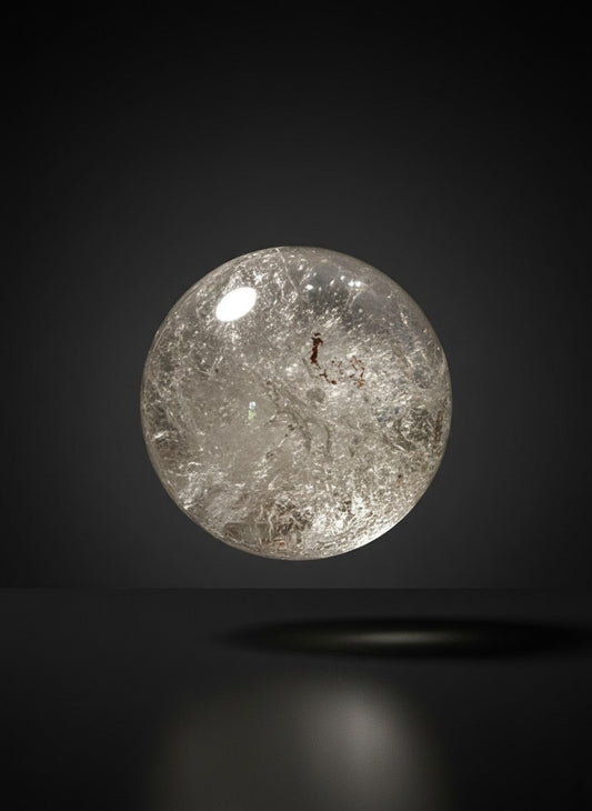 Zebra Industries, LLC collector grade garden quartz sphere with natural iron oxide inclusions on a dark background.