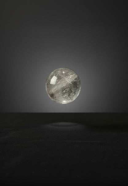 Zebra Industries, LLC 2-inch polished Garden Quartz sphere with natural internal inclusions on a dark background.