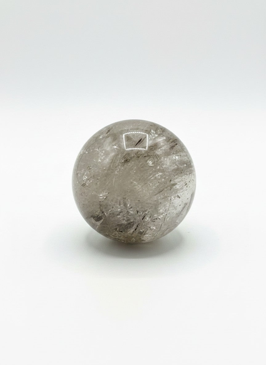 Zebra Industries, LLC polished garden quartz crystal sphere with natural inclusions and clear mineral formations.