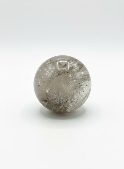Zebra Industries, LLC polished garden quartz crystal sphere with natural inclusions and clear mineral formations.