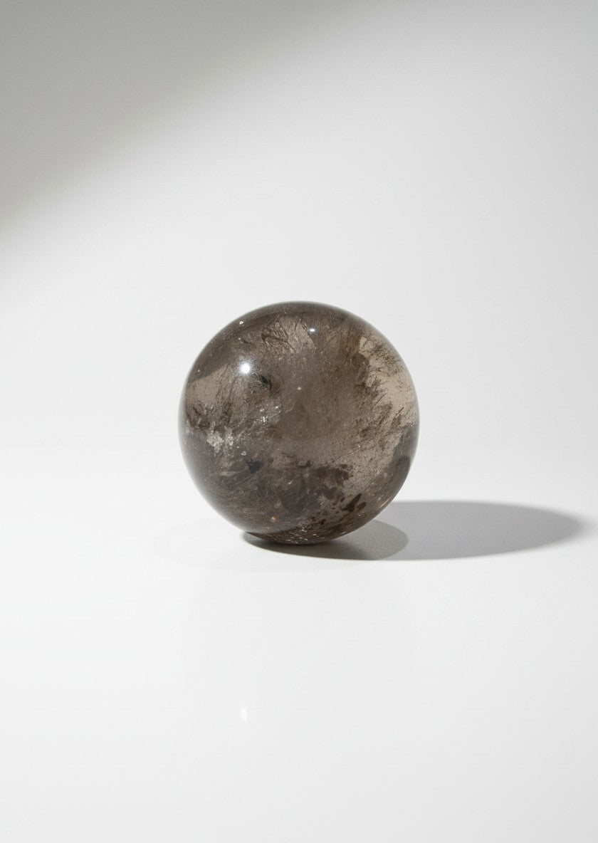 Zebra Industries, LLC collector grade polished garden quartz sphere with natural inclusions on a white background