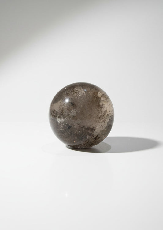 Zebra Industries, LLC collector grade polished garden quartz sphere with natural inclusions on a white background