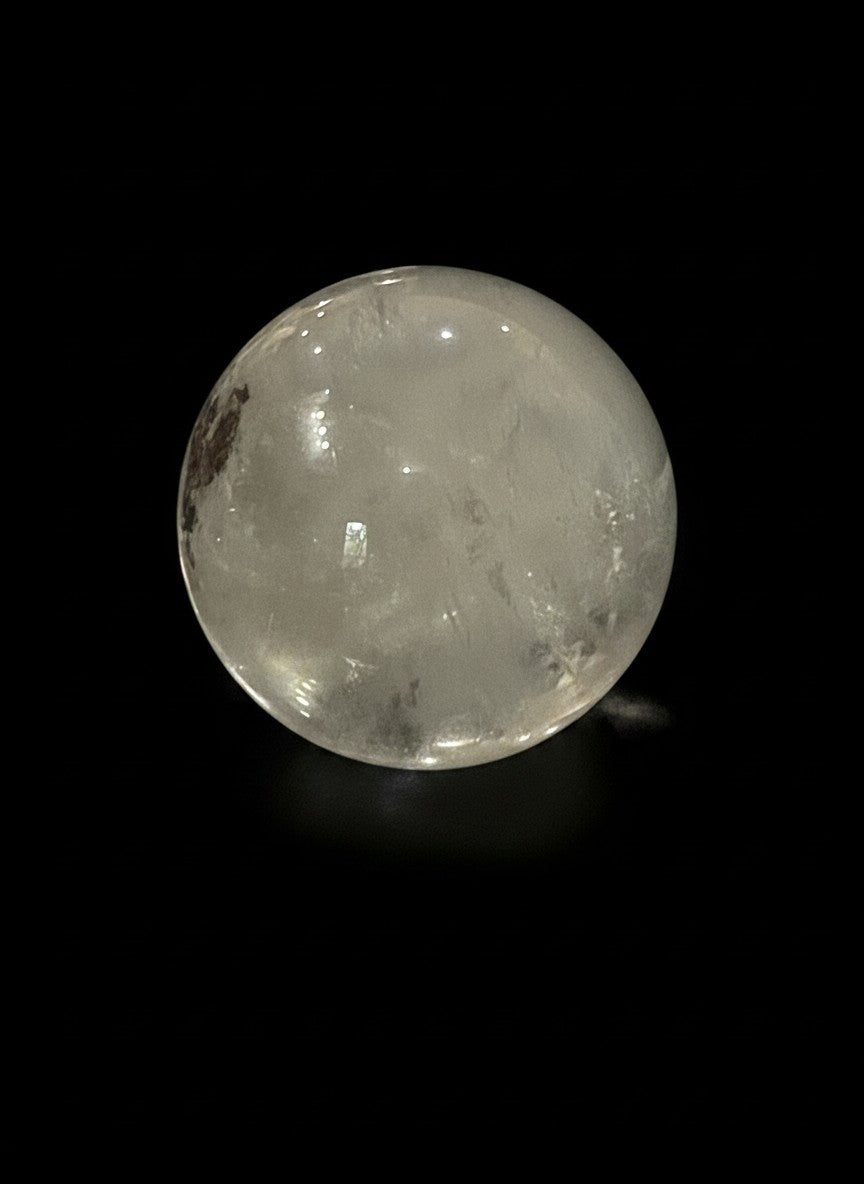 Zebra Industries, LLC collector-grade polished garden quartz sphere with natural clarity on a black background.