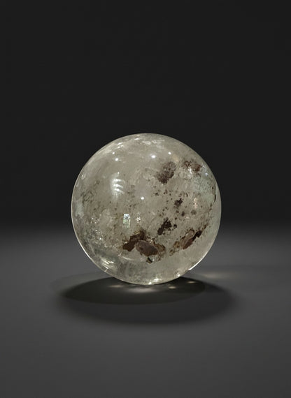Zebra Industries, LLC garden quartz sphere with hematite inclusions and iron oxide patterns in a clear crystal matrix.