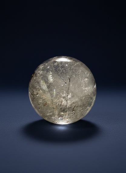 Zebra Industries, LLC polished garden quartz sphere with natural mineral inclusions and clear, smooth finish.