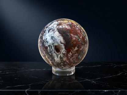 Zebra Industries, LLC Laguna Lace agate sphere with natural druzy cavity and intricate mineral patterns on a stand.
