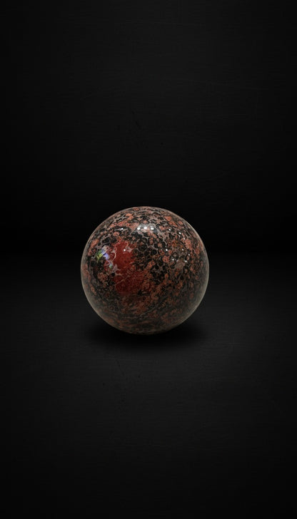 Zebra Industries, LLC polished leopard skin jasper sphere featuring a dark matrix with reddish-tan orbicular inclusions.