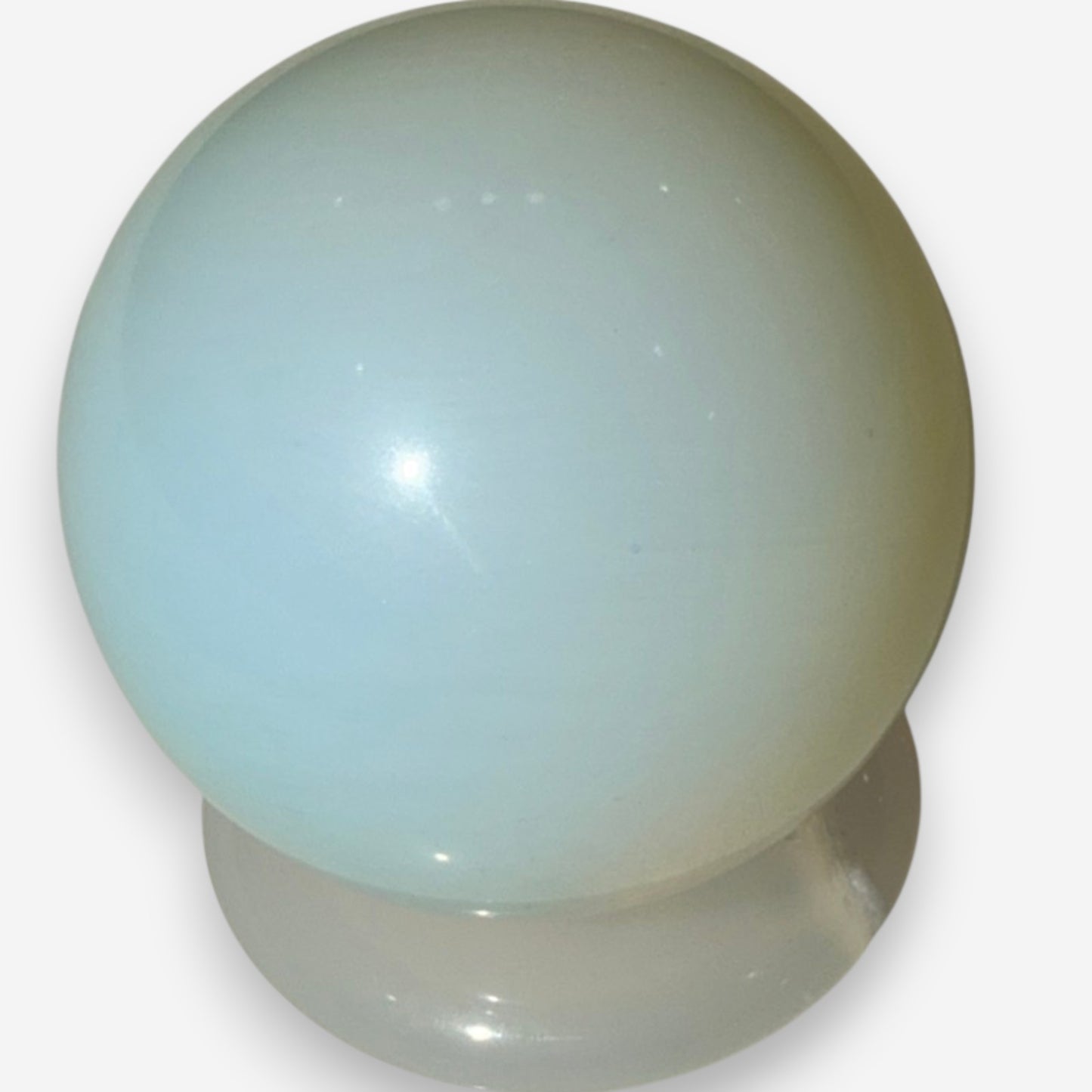 Zebra Industries, LLC polished opalite glass sphere with a milky aqua-blue color and iridescent glow.