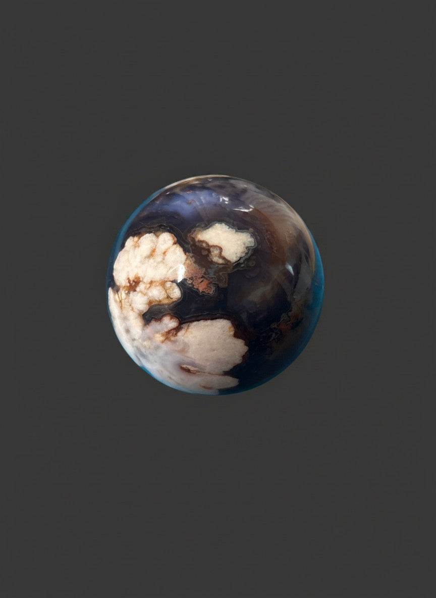 Zebra Industries, LLC polished agate sphere featuring deep blue-purple chalcedony and organic white druzy inclusions.