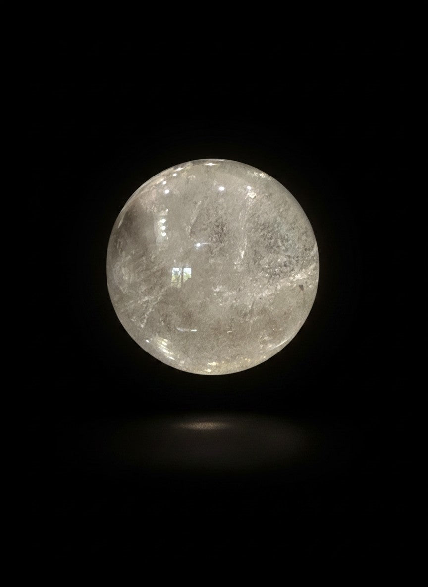 Zebra Industries, LLC collector-grade polished garden quartz sphere with natural clarity on a black background.